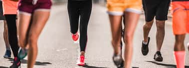 Large group of unrecognizable marathon runners having a race on the road.