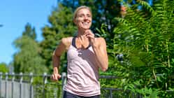 Happy healthy woman jogging outdoors