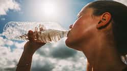 Eine Sportlerin trinkt Wasser.