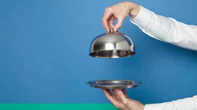 hands holding silver tray and lid