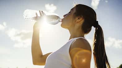 Photo of a woman running while sun is setting