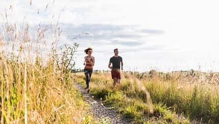Laufendes Paar auf einem Feldweg