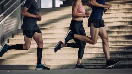 Urban Workouts: Group of Three Unrecognizable People Running Together