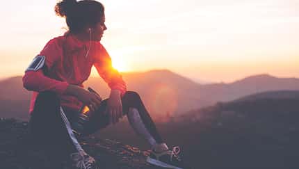 Fit woman athlete resting outdoors