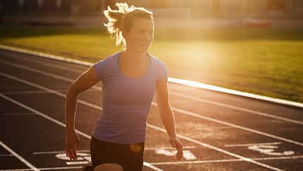 Woman running on track