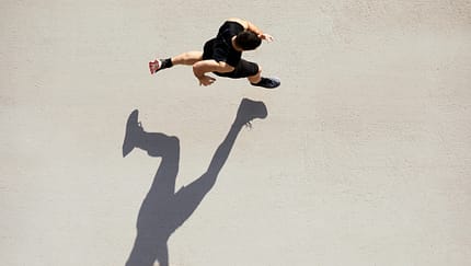 Sprinter seen from above with shadow and copy space.