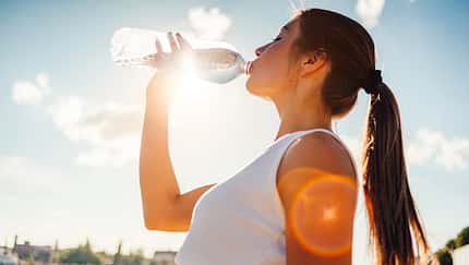 Photo of a woman running while sun is setting