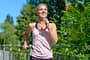 Happy healthy woman jogging outdoors