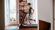 Woman training on treadmill at home